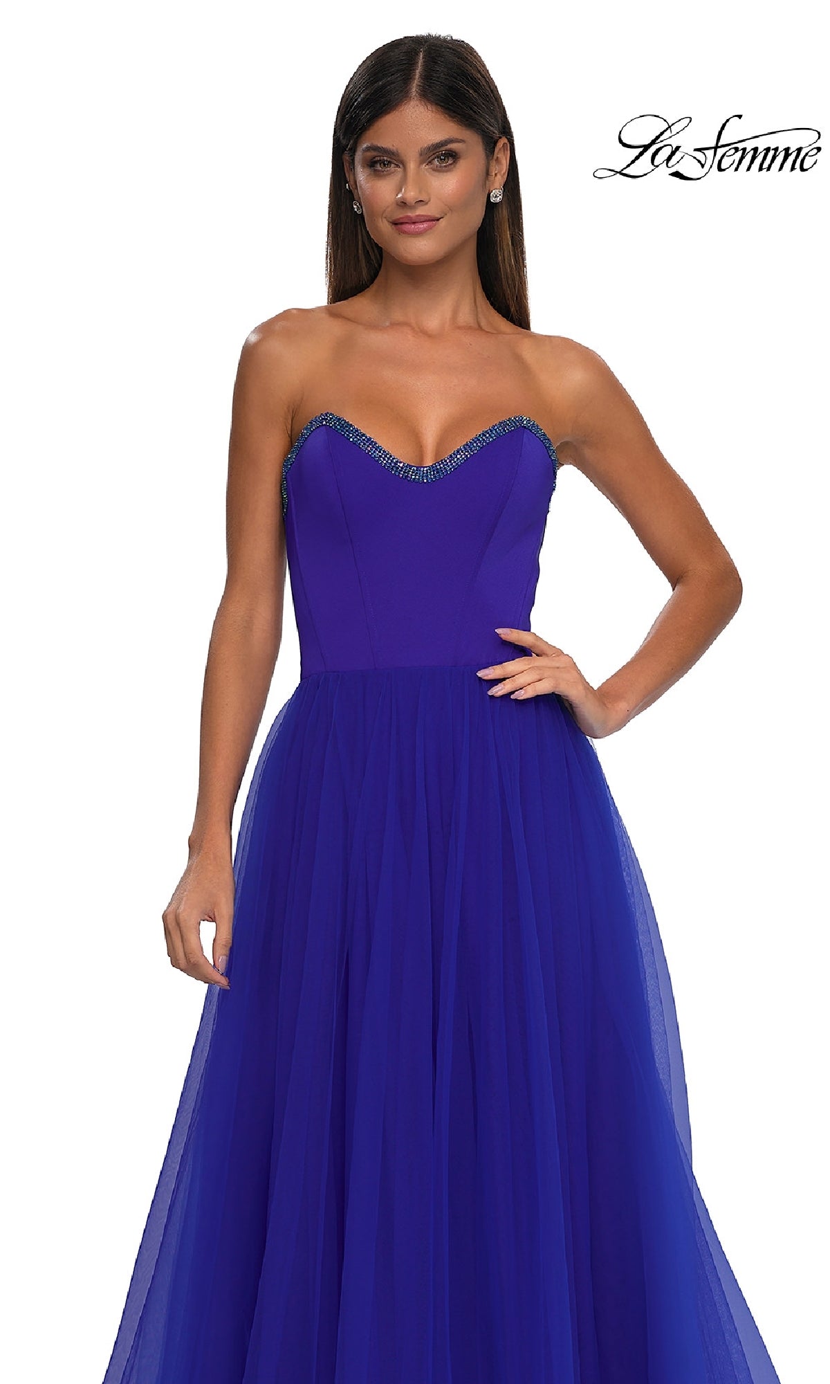 A woman wears the La Femme 32731 strapless long prom ball gown—a floor-length royal blue dress with a sweetheart neckline and beaded trim. The La Femme logo appears in the top right corner.
